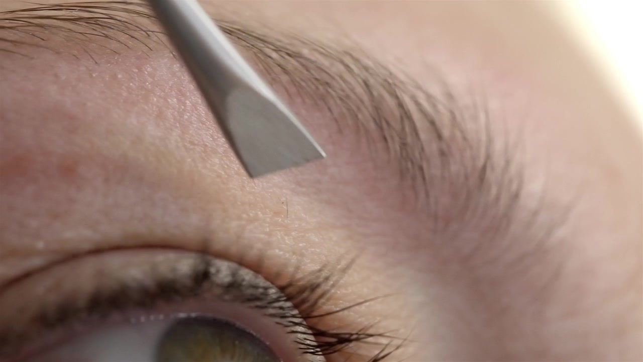 Detail of skin exfoliation procedure or eyebrow shaping with beauty