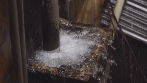 Overflowing-rain-drainage-in-an-old-apartment-during-heavy-rain