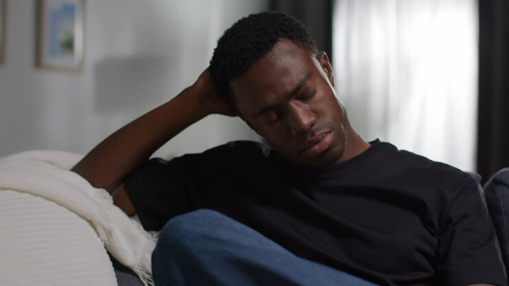Unhappy And Depressed Young Man Sitting On Sofa At Home Looking Anxious And Worried Resting Head On Hand 5