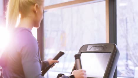 fit woman exercising on cross trainer