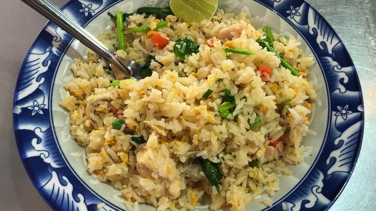 Egg fried rice dish, Asian style with lemon and meat in restaurant, food