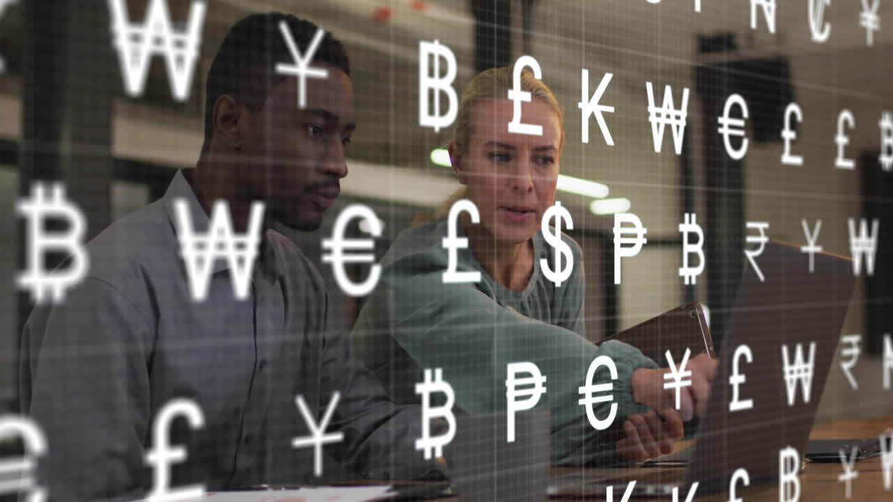 Animation of currency symbols over diverse colleagues using laptop in office