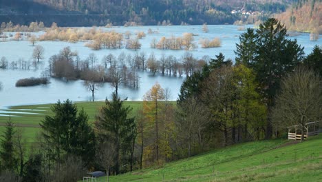 panoramic view of a flooded planina field with the nearby village, slovenia