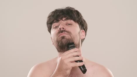 man shaving his beard