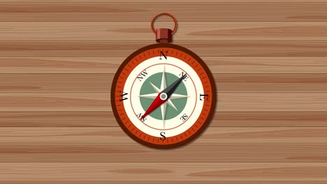 compass needle rotates over wooden surface background