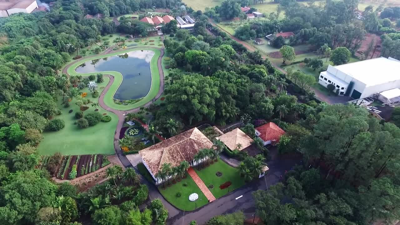 Old farmhouse near lake in interior of Brazil. Aerial high angle rising