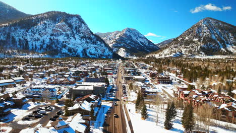 winter bluebird sky daytime snowy downtown frisco aerial drone ten mile range main street colorado mountain ski town copper ikon pass breckenridge silverthorne dillon summit county forward pan reveal