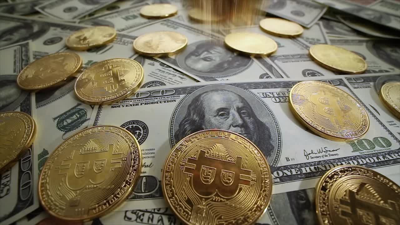 Gold Bit Coin BTC coins and dollar bills.
