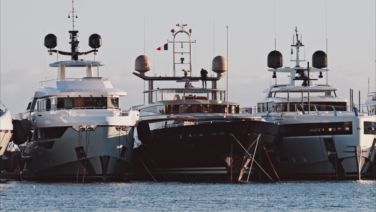 View of a man working on a boat docked in the Port de Cannes in France