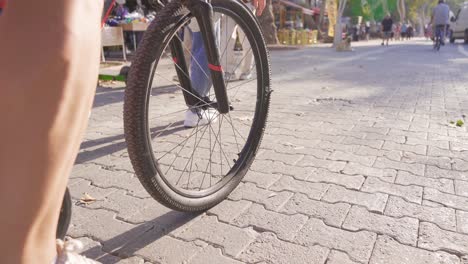 young man cycling on busy street.