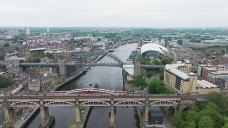 Newcastle-upon-tyne-showcasing-bridges-and-cityscape-on-a-cloudy-day,-aerial-view