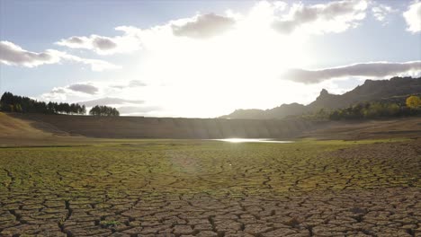 time lapse of a dried out lake and a dam during summer drought