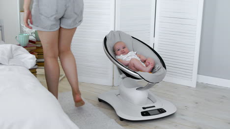 modern high-tech rocking chair helps parents put the child to bed. white interior of children's room