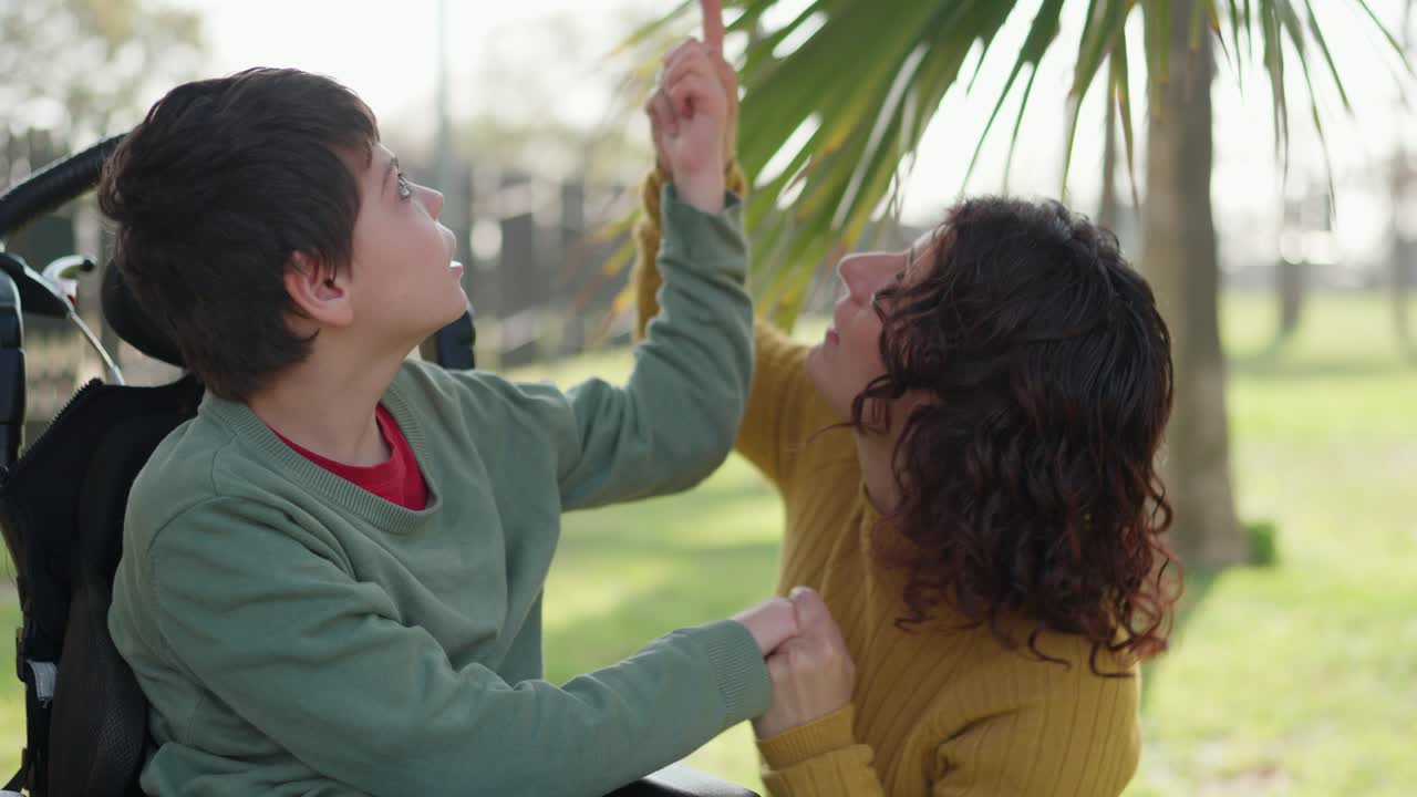 Mother and child with disability in park