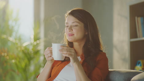 woman enjoying a warm drink at home