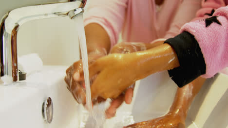 grandmother and granddaughter washing hands in bathroom sink 4k