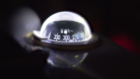 marine compass on a sailing yacht at night. backlit compass