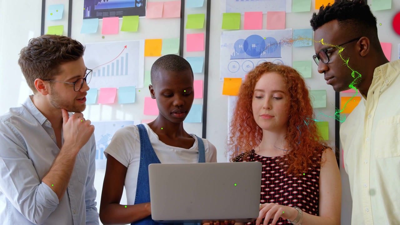 Business team reviewing at laptop, lead woman starting typing while animated dots marking charts