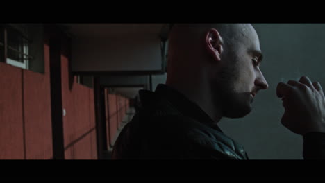 a bald gang member on guard