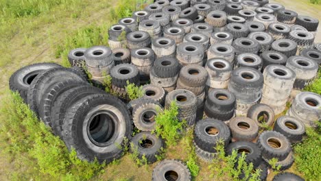 4k drone video of discarded giant excavator tire pile in wilderness near fairbanks, ak during summer day-10