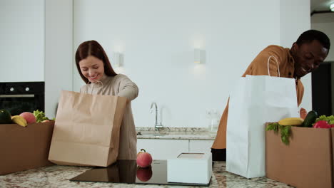 couple unpacking groceries