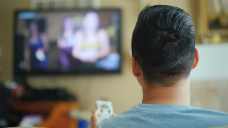 Asian-Man-Watching-Tv-Rear-View
