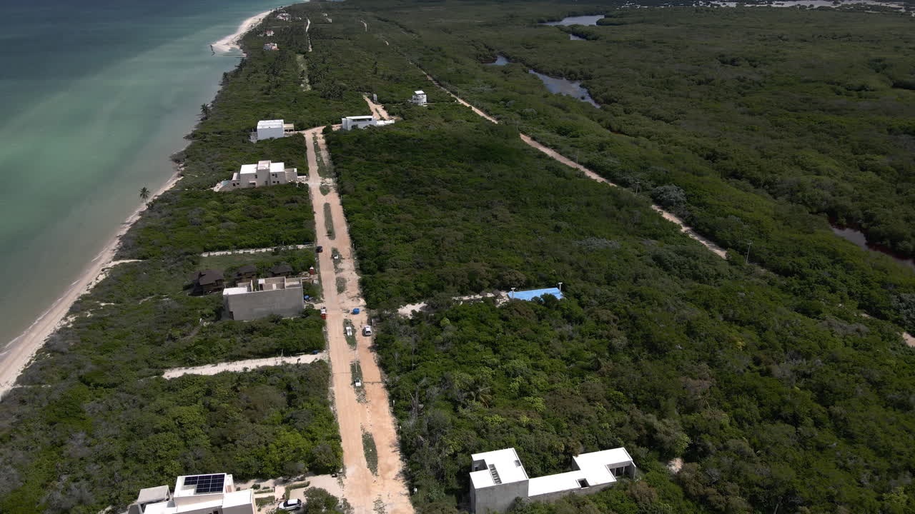Sisal Aerial View 4K Empty Yucatan Beach On Mexican coast showing Sisal development growth