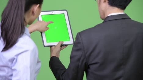 young asian business couple using digital tablet together