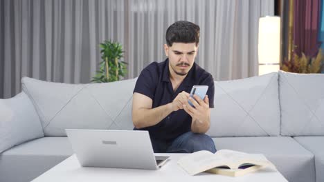 Confused-young-man-using-phone.