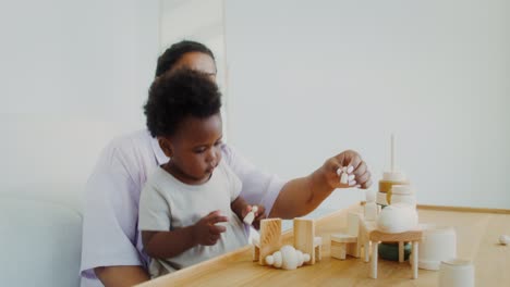 mother and child playing with wooden blocks