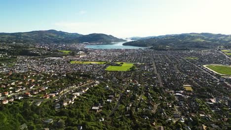 aerial panning panoramic view of dunedin central area in otago bay at sunny day