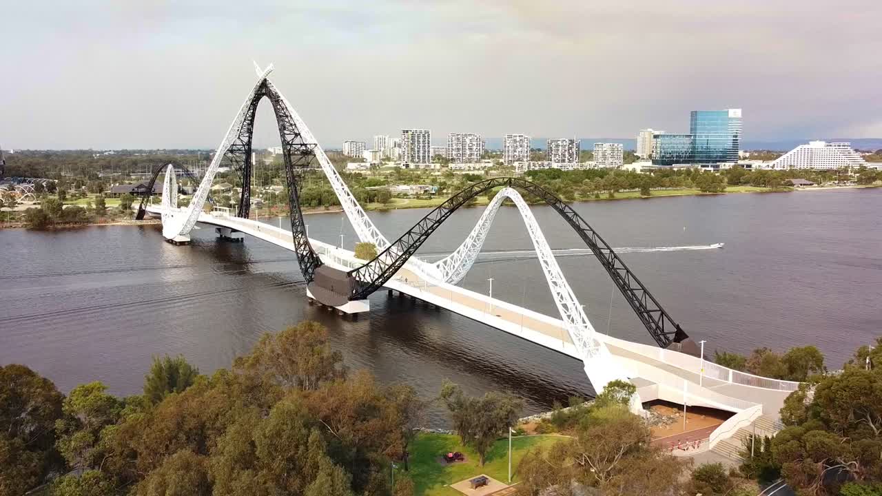 Speedboat passing under the Matagarup Bridge across the Swan River, Perth