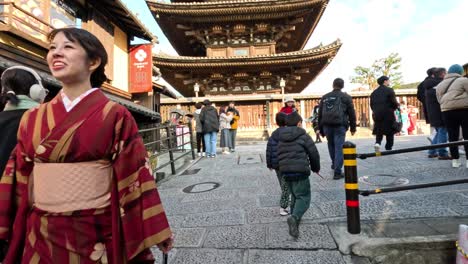 visitors walking near traditional japanese temple