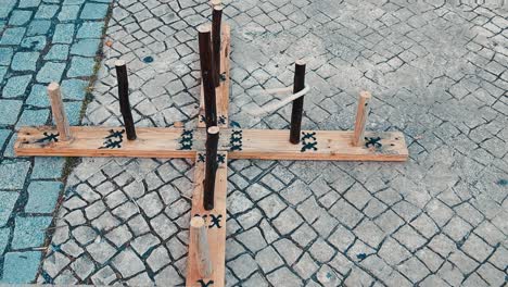 medieval outdoor entertainment wooden game middle ages involves the throwing of metal, rope or rubber rings over a set distance, usually to land over or near a spike called a hob, mott or pin