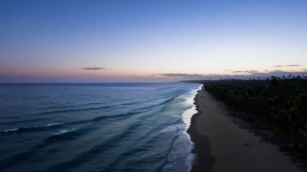 las suaves olas que rodan sobre una playa tropical crean una atmósfera serena durante una impresionante puesta de sol