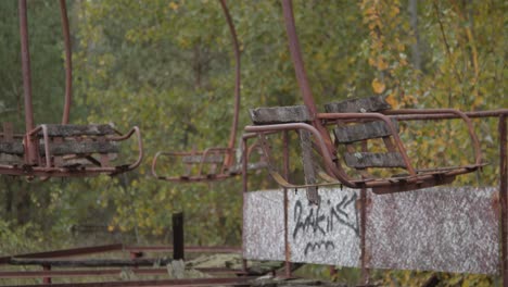 broken sitting and rusty metal of paratrooper ride at the deserted and abandoned amusement park in the city of pripyat in chernobyl exclusion zone, ukraine in autumn