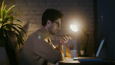 man working on a laptop at night