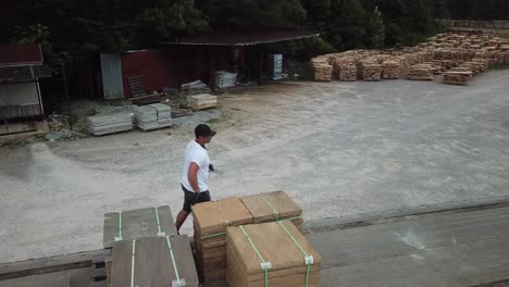 aerial of worker sorting building stone on truckbed