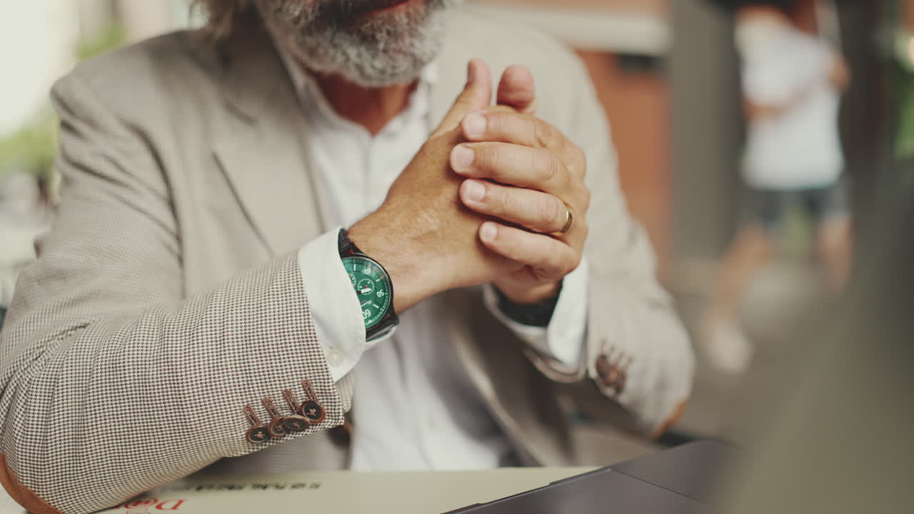 Close-up of a man's hands wearing a watch