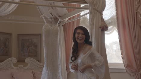 bride getting ready to try on wedding dress