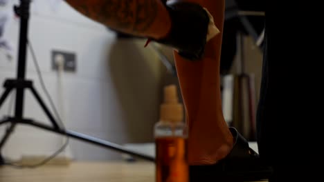 artist wiping and cleaning the skin before creating a calf tattoo