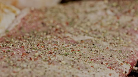 Macro-close-up-of-BBQ-pork-ribs-being-placed-on-hot-grill