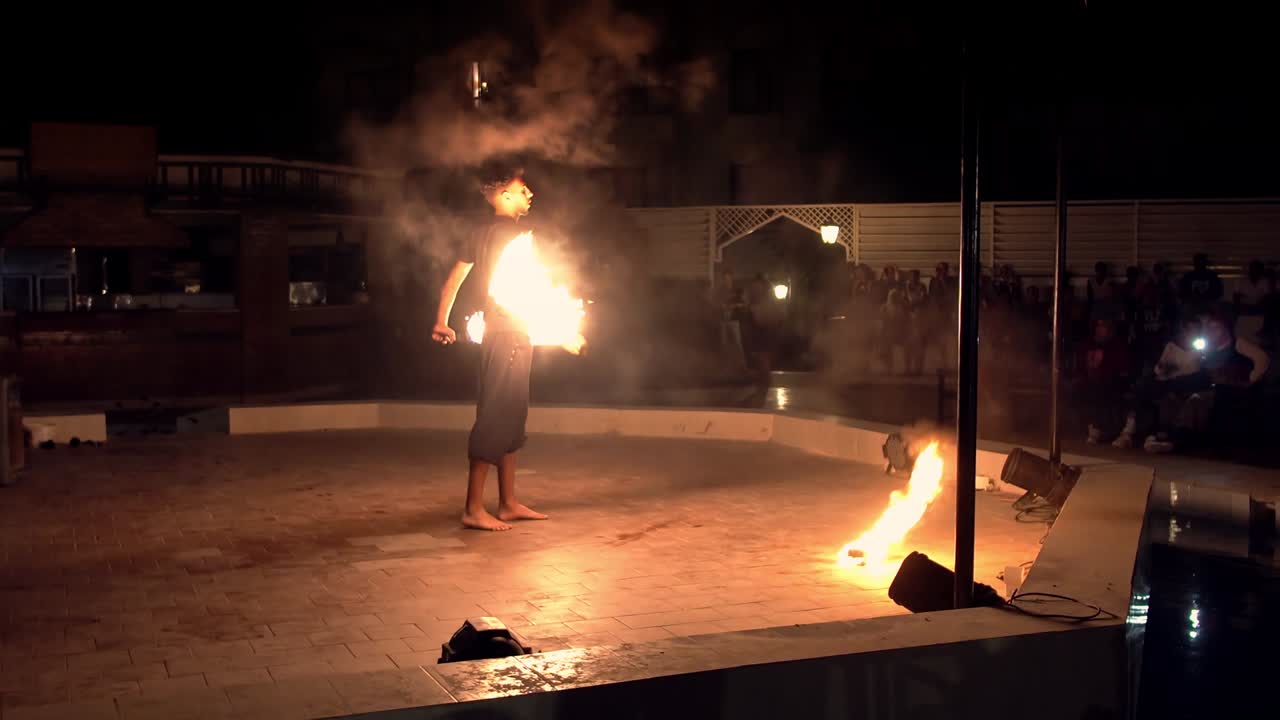 Fire preformance of artists juggling with burning poi's at fire performance