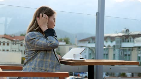 charming young business lady work on tablet at cafe