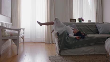 happy little girl wearing ballet tutu lying on sofa playing having fun child in playful mood enjoying weekend morning at home 4k footage