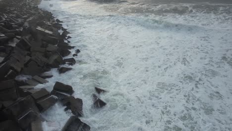 powerful waves crashing on pier