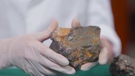 close-up of a geologist examining a rock sample