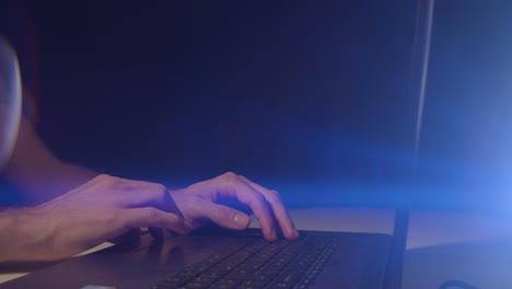 working from home male hands using trackpad mouse on a laptop with cinematic lens flare