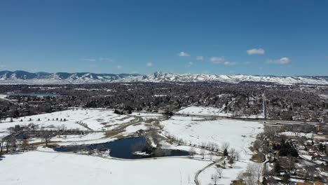 A-drone-pan-over-a-park-after-a-spring-snow-storm