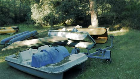 A-few-abandoned-pedal-boats-near-a-lake